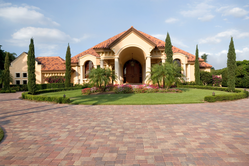 large home with palm trees out front